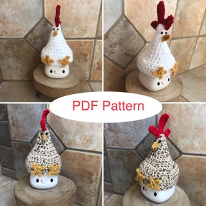 May include: Four crocheted chicken mug toppers, two white and two brown, with red combs and yellow stars. The toppers are shown on top of white mugs with happy faces. The image includes the text "PDF Pattern".