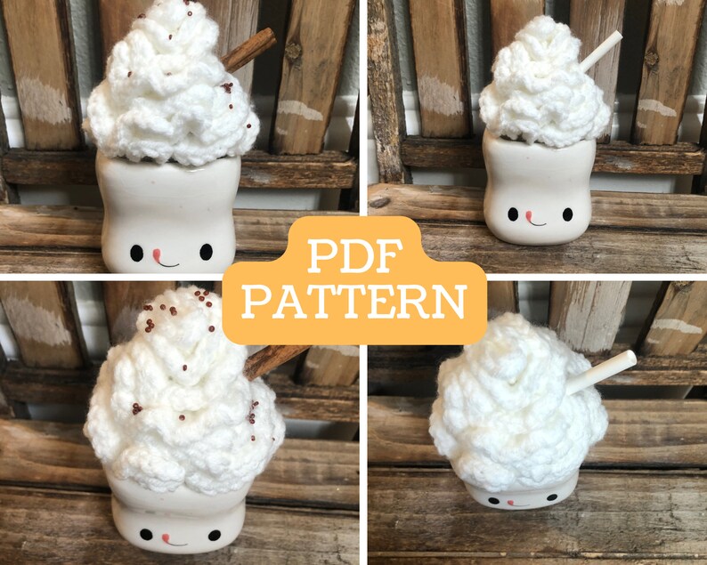 May include: Crochet pattern for a white marshmallow mug with a smiling face. The mug is topped with a white crocheted whipped cream with brown sprinkles and a cinnamon stick. The pattern is available as a PDF download.