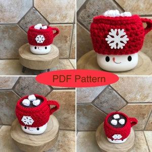May include: A crochet pattern for a red and white hot chocolate mug cozy with a snowflake design. The cozy is made to fit a standard-sized mug. The pattern is available as a PDF download. "PDF Pattern" is written in red letters on a white background.