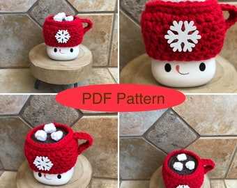 May include: A crochet pattern for a red and white hot chocolate mug cozy with a snowflake design. The cozy is made to fit a standard-sized mug. The pattern is available as a PDF download. "PDF Pattern" is written in red letters on a white background.