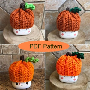 May include: A crochet pumpkin hat pattern in PDF format. The pattern is for a small pumpkin hat that can be used as a mug cozy. The hat is orange with green leaves and a brown stem.