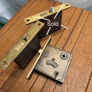 May include: A set of three ceramic mugs with a speckled, matte finish. The mugs are in shades of cream, light gray, and dark gray. Each mug has a simple, minimalist design, perfect for coffee or tea.