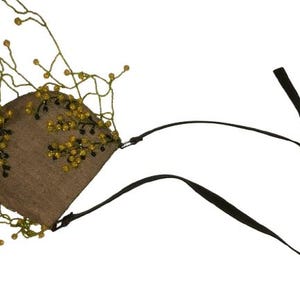 May include: A small brown purse with a beaded fringe and a black adjustable strap. The beads are yellow and green.