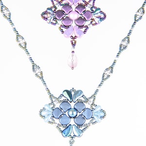 May include: A delicate beaded necklace with two pendant charms. The top charm is a purple flower with iridescent accents. The bottom charm is a blue flower with iridescent accents.