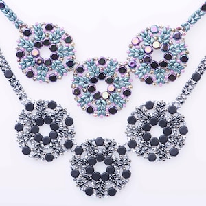 May include: A necklace with five beaded circles, three are blue and purple, and two are black and silver.