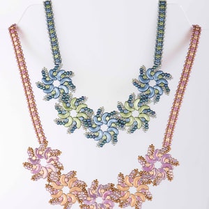 May include: Two beaded necklaces with a floral design. The top necklace is blue, green, and silver. The bottom necklace is pink, brown, and gold.