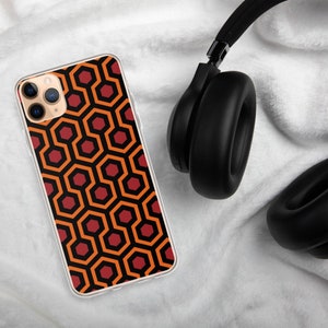 May include: A clear phone case with a red and orange geometric pattern. The pattern is reminiscent of the Overlook Hotel carpet from the movie "The Shining".