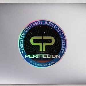 May include: A silver laptop with a holographic sticker featuring the text "Pansystem University Mihira-New Tideland" and "Perihelion" with a stylized "P" logo. The sticker has a rainbow iridescent effect.