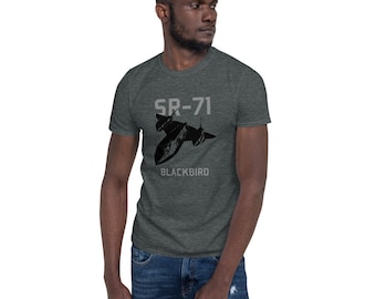 May include: Dark gray t-shirt featuring a black SR-71 Blackbird aircraft graphic. The text "SR-71" and "Blackbird" are printed above and below the aircraft illustration. The shirt is made of a soft material.