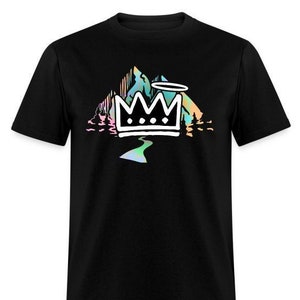 May include: Black t-shirt with a graphic of a crown in front of a mountain range with a halo above it. The mountains are in a rainbow color scheme.