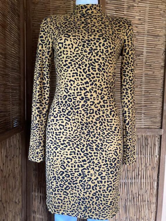 Sweater dress, mock turtle neck, long sleeve, above knee, leopard print. Sweater dress, mock turtle neck, long sleeve, above knee, leopard print.