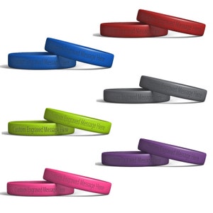 May include: A set of ten silicone wristbands in various colors, each with the text "Custom Engraved Message Here" printed on them.