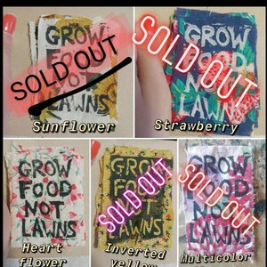 May include: Four fabric patches with the text "Grow Food Not Lawns" in black lettering. The patches are in different colors and patterns: sunflower, strawberry, heart flower, and inverted yellow. All patches have a red "Sold Out" stamp.