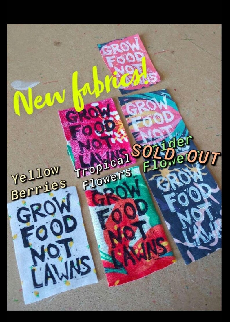 May include: Five fabric swatches with the text "Grow Food Not Lawns" printed on them. The swatches feature different designs, including yellow berries, tropical flowers, and a black and white design. The text "Sold Out" is written on the image.