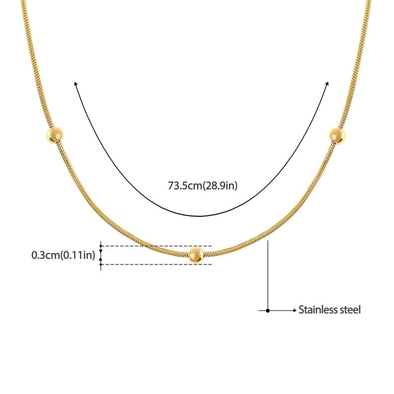 May include: A gold chain necklace with three small round beads. The necklace is 28.9 inches long and 0.11 inches wide. The chain is made of stainless steel.