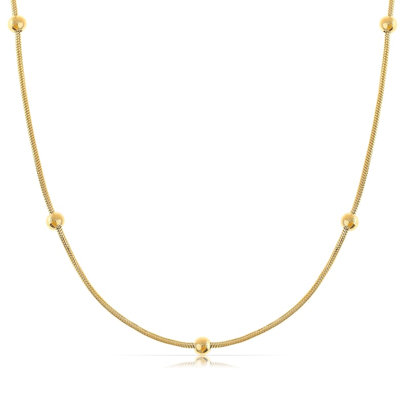 May include: A gold chain necklace with five round beads.