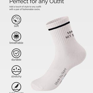 May include: White crew socks with a black stripe and the text "SOF NOTS" printed on the side. The socks are made by Nami and have the text "Live Free" printed on the bottom.