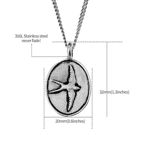 May include: Silver necklace with a round pendant featuring a stylized swallow in flight. The pendant measures 1.3 inches in diameter and 0.8 inches in width. The chain is made of 316L stainless steel, which is known for its durability and resistance to tarnishing.