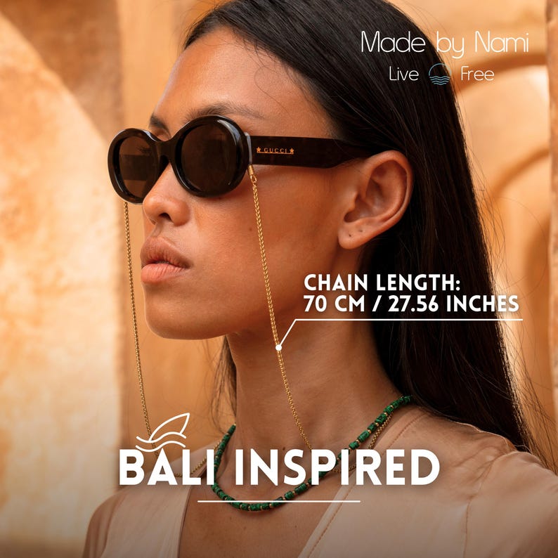 May include: A woman wearing black round sunglasses with a gold chain attached to the temples. The chain is 70 cm or 27.56 inches long. The woman is wearing a green beaded necklace and a white shirt. The text "Made by Nami" and "Live Free" is visible in the top right corner of the image. The text "BALI INSPIRED" is visible in the bottom center of the image.