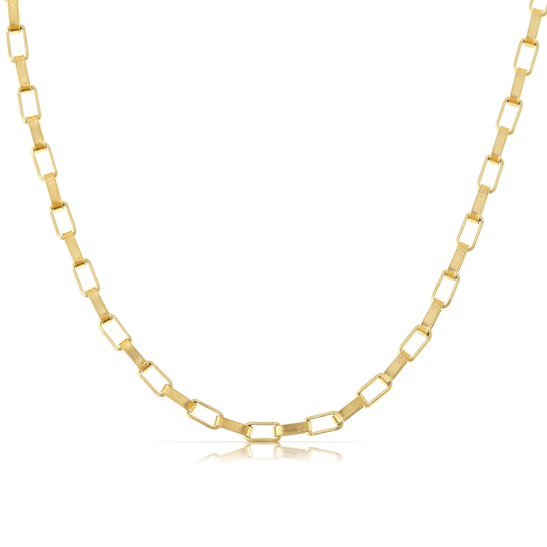 May include: A gold chain necklace with a square link design.