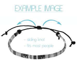 May include: Black and white woven bracelet with a sliding knot closure. The bracelet is adjustable to fit most people.