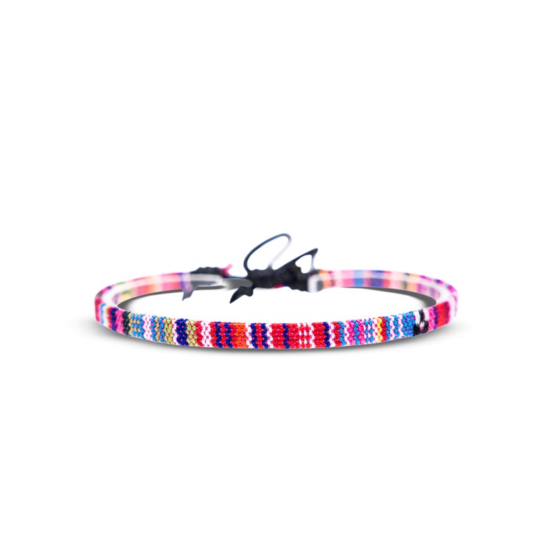 May include: A colorful woven bracelet with a black clasp. The bracelet features a variety of colors, including red, blue, green, yellow, and white.