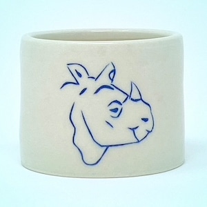 May include: White ceramic mug with a blue line drawing of a rhinoceros on the side.