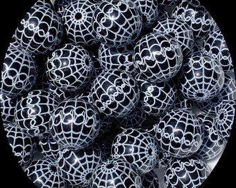 May include: A collection of black and white round beads. Each bead is decorated with a white spiderweb design. The beads are spherical and have a glossy finish. These beads are suitable for jewelry making and craft projects.