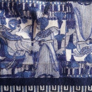 May include: Blue and white fabric with a repeating pattern of stylised figures and geometric designs. The fabric has a textured surface and a dark blue border.