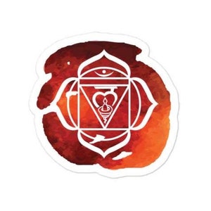 May include: A white sticker featuring a stylized, geometric design of a chakra symbol. The symbol is set against a watercolor background of red, orange, and brown hues. The design is intricate and detailed.