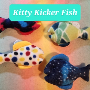May include: Four plush fish toys in different colors and patterns. The fish are made of soft fabric and have a variety of colors and designs. The fish are designed to be kicked by cats.