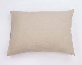 May include: A plain beige linen pillow with a smooth, even texture.