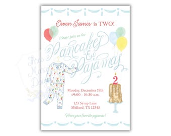 May include: A white invitation with the text "Owen James is TWO!" and "Pancakes & Pajamas." The invitation includes illustrations of pajamas, balloons, and a stack of pancakes with a candle. The event details are also included.