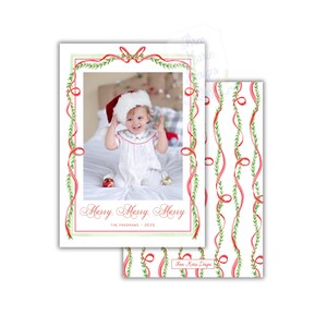 May include: Christmas card featuring a photo of a baby wearing a Santa hat, framed by red ribbons and green foliage. The card reads "Merry Merry Merry" and "The Freemans - 2025". A matching patterned design is visible on the back of the card.