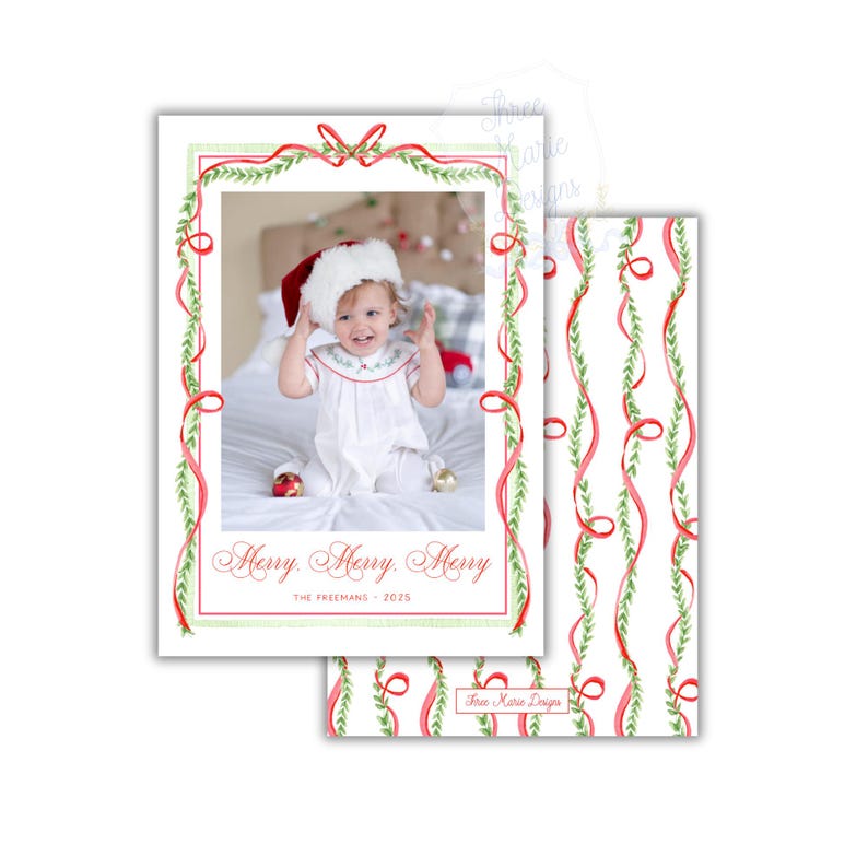 May include: Christmas card featuring a photo of a baby wearing a Santa hat, framed by red ribbons and green foliage. The card reads "Merry Merry Merry" and "The Freemans - 2025". A matching patterned design is visible on the back of the card.