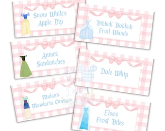 May include: Printable food labels featuring Disney princesses. The labels have a pink and white gingham pattern with a princess illustration and text. The labels read: Snow White's Apple Dip, Bibbidi Bobbidi Fruit Wands, Anna's Sandwiches, Mulan's Mandarin Oranges, Dole Whip, and Elsa's Frost Bites.