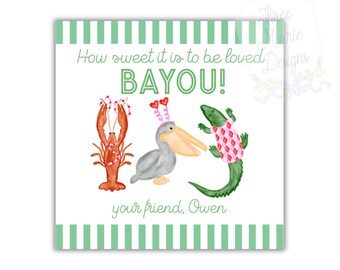 May include: Square card with a green and white striped border. The card features a watercolor illustration of a crawfish, pelican, and alligator. Text reads "How sweet it is to be loved BAYOU!" and "your friend, Owen."