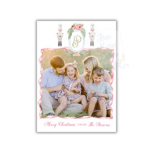 May include: A Christmas card featuring a family portrait with a pink and white border. The card includes watercolor illustrations of nutcrackers and floral elements. The text "Merry Christmas FROM The Parsons" is written at the bottom.