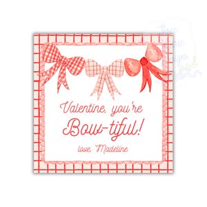 May include: A square Valentine's Day card with a red and white gingham border. The card features three watercolor bows in red hues. Text reads "Valentine, you're Bow-tiful!" and "love, Madeline".