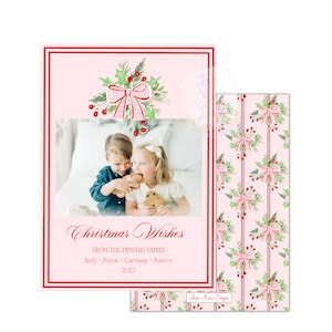 May include: A pink Christmas card with a photo of two children eating gingerbread cookies. The card features a red border, holly and bow illustrations, and the text "Christmas Wishes" with the family name and year.