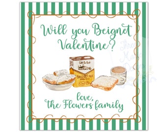 Op de afbeelding: Vierkante kaart met een groen-witte gestreepte rand en een bruine decoratieve lijst. De kaart bevat aquarel illustraties van beignets, een kopje koffie en een doos beignetmix. Tekst luidt: "Will you Beignet Valentine? love, the Flowers family."