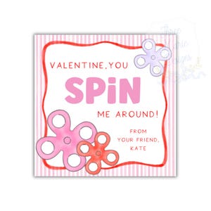 May include: A Valentine's Day card with a pink and red color scheme. The card features the words "VALENTINE, YOU SPIN ME AROUND!" in pink, along with three flower-shaped fidget spinners. The card is signed "FROM YOUR FRIEND, KATE."