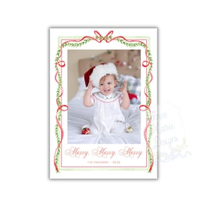 May include: Christmas card featuring a child wearing a Santa hat and white outfit. The card has a watercolor design with a red and green border, and the words "Merry Merry Merry" are written in elegant script. The family name and year are also included.