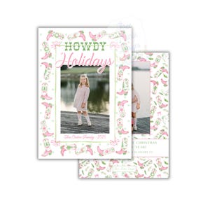 May include: Holiday card design with a photo of a young girl. The card features the text "Howdy Holidays" in green and pink, with a border of pink cowboy boots and floral accents. The family name and year are also included.