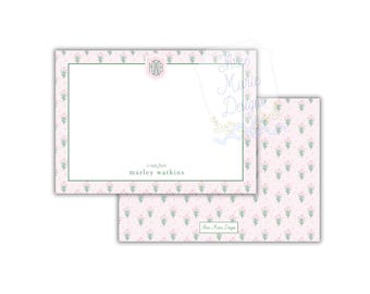 May include: Stationery set featuring a pink floral pattern and a green border. The notecard includes the text "a note from marley watkins" and a monogram. The back of the card has a matching floral design.