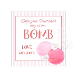 May include: A Valentine's Day card with a pink and white striped border. The card features the text "Hope your Valentine's day is the BOMB" and "LOVE, AMY JONES". Two pink bath bombs and candy hearts are also shown.