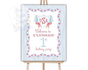 Puede incluir: Bienvenido a la fiesta de cumpleaños número 1 de Ulises con un gráfico de EE. UU. rojo, blanco y azul con estrellas y rayas. El letrero está en un caballete de madera.