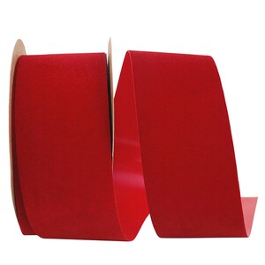 May include: A roll of red velvet ribbon. The ribbon is 1.5 inches wide and is perfect for adding a touch of elegance to any project.