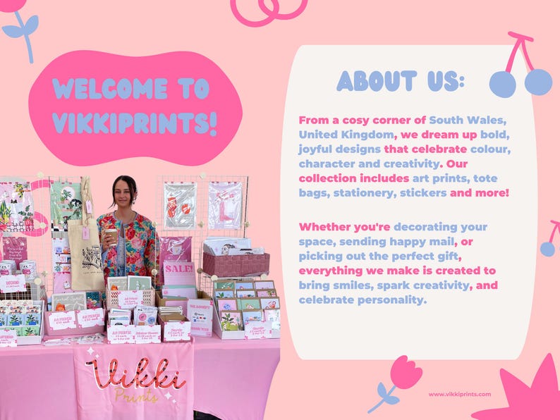 May include: A pink display table with various art prints, tote bags, and stationery. The text "WELCOME TO VIKKIPRINTS!" is displayed above the table. The display includes the text "SALE" and "ABOUT US:" with a description of the brand.