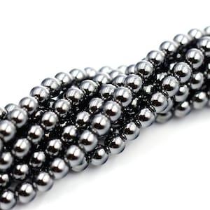 May include: A strand of black hematite beads, each bead is round and smooth with a high polish.